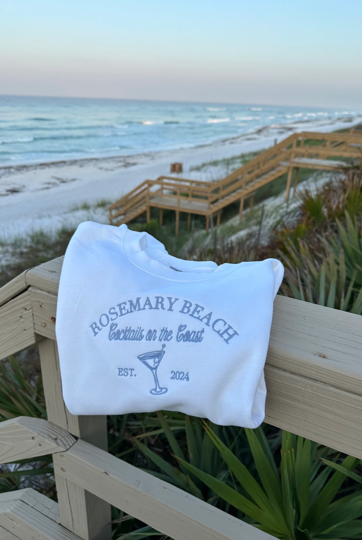 Cocktails on the Coast Themed Embroidered Crewneck in white on beach