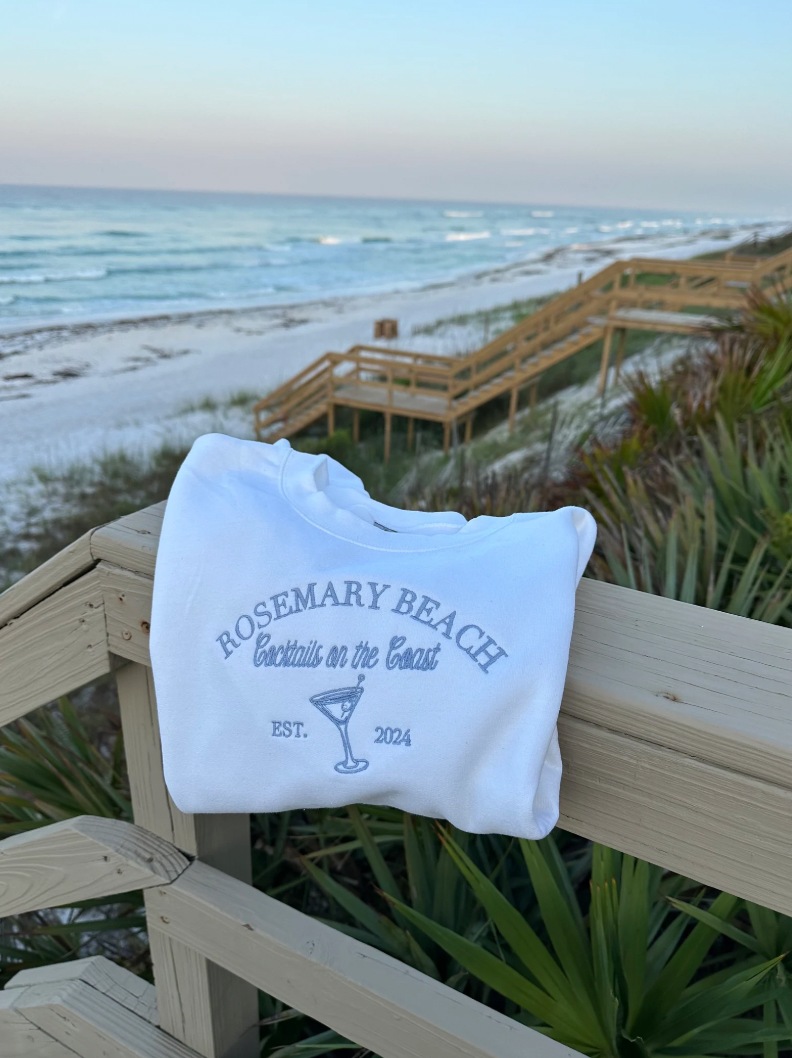 Cocktails on the Coast Themed Embroidered Crewneck in white on beach